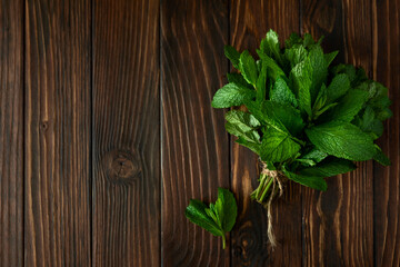 Fresh mint on wooden rustic background. Top view. Copy space