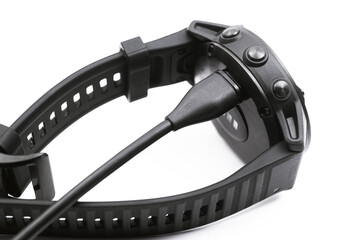 Obraz premium Smart watch charge concept. Charging fitness tracker isolated on white background