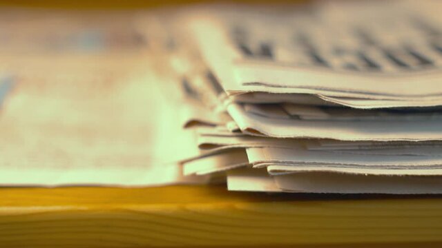 A Stack of Old Newspapers, Publications, Papers, Articles on the Table in the office