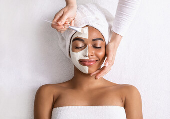 Black woman with white mask on half of her face