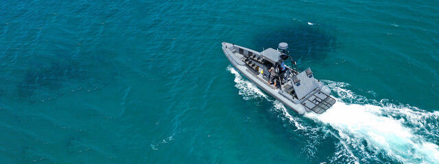 Aerial drone ultra wide photo of rigid inflatable speed boat cruising in deep blue Aegean sea,...