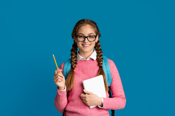 Good student. Smiling teenage girl holding notebook and pencil