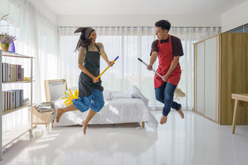 Fototapeta na wymiar couple husband and wife have fun together for housework and houseclean