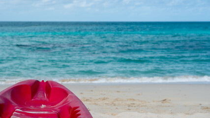 Background of beautiful summer holiday vacation on white clean sand beach clear sea water quite wave with red Kayak boat for fun active activity 