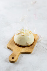 Raw almond cake with falling flower petals. No sugar, gluten, lactose.