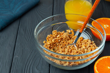 Bowl with granola on wooden table close up