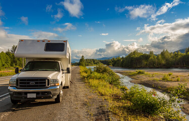Campervan parked beside the Kitimat River in the evening sun.