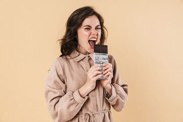 Image of young caucasian woman eating chocolate on camera