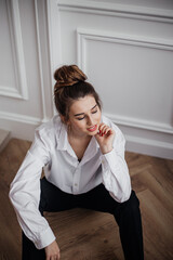 young woman sitting on the floor