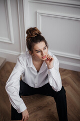 young woman sitting on the floor