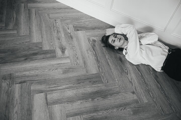 Beautiful girl lies on the floor and smiles
