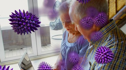 Covid-19 cells moving against senior couple using laptop - Powered by Adobe
