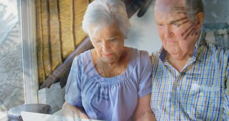 Covid-19 cells moving against senior couple using laptop - Powered by Adobe