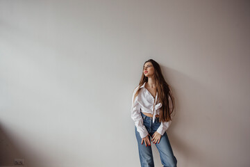 young woman painting wall with roller