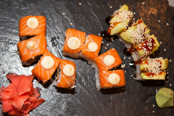 Sushi with salmon on a black board