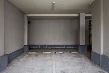 Underground car parking lot. Indoor parking area. Concrete basement floor parking garage