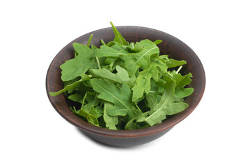 Fresh leaves of arugula in ceramic brown bowl isolated.