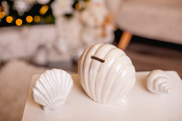 Fototapeta na wymiar piggy bank for money in the form of a seashell on a New Year's background