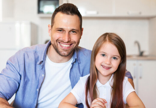 Little Girl And Her Dad Smiling Posing In Kitchen Indoor