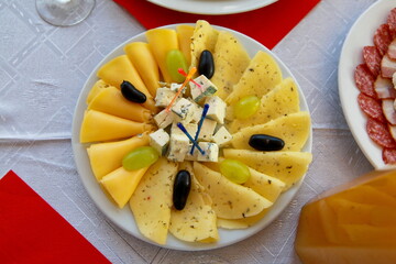 plate with different cheese and grapes in a restaurant