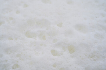 white background of foam and fresh milk bubbles