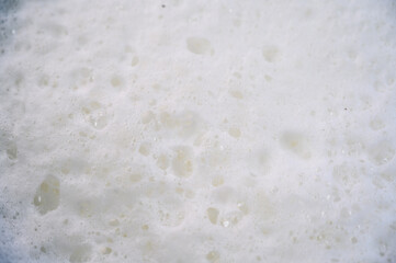 white background of foam and fresh milk bubbles
