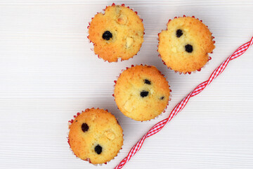 Delicious homemade vanilla muffins with raisins and pieces of white chocolate