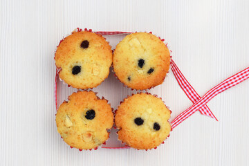 Delicious homemade vanilla muffins with raisins and pieces of white chocolate