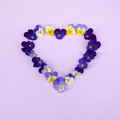 The pansies are laid out in the shape of a heart . The concept of love for Mother's Day or Valentine's Day