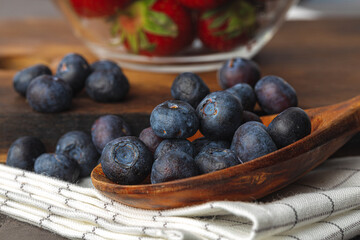 Bowl of fresh blueberry on kitchen table close up