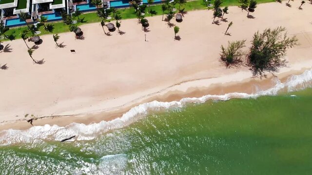High quality royalty free stock footage, Aerial view of tropical sandy beach with palms and calm sea . Shot in Vietnam ,Phu Quoc, Romantic beach from the top video concept with beach resorts