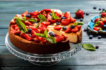 Delicious cheesecake with berries on table close up.