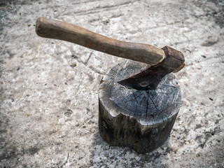 Vintage rusty сhopper in a block standing on a grey concrete floor left by lumberjack. Brutal...