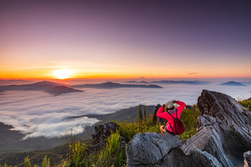 Young girl in red jacket hiking on the mountain, Doy-pha-tang, border  of  Thailand and Laos.