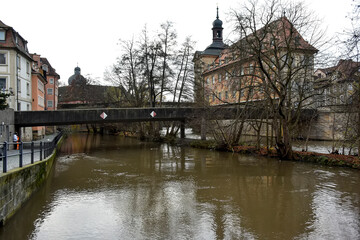 Fototapeta na wymiar View of the Regnitz River and Old town hall or Altes Rathaus with two bridges in Bamberg, Bavaria, Franconia, Germany. 