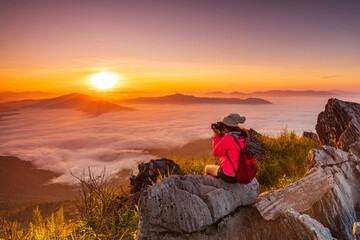 Young girl in red jacket hiking on the mountain, Doy-pha-tang, border  of  Thailand and Laos.