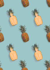 Seamless pineapple slices pattern on blue background