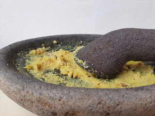 Mashed seasoning, from garlic, candlenut, salt and pepper. Handmade, traditionally made with stone mortar. Basic seasoning for various Indonesian cuisine