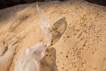 a plastic bag stuck in the sand