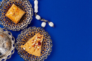 Turkish dessert in metal traditional plate on blue background