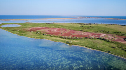 amazing aerial view of blue and pink lakes, sea on horizon. Beautiful natural landscape. Drone shot, bird's eye.