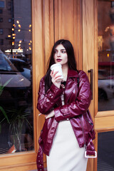 young pretty girl outside in city street with coffee happy smiling, lifestyle fashion peopple concept