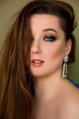 Fototapeta premium Tender and lovely girl model woman with makeup on the background with a hairstyle