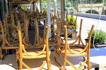 Greece, Athens, June 17 2020 - Chairs stacked outside of a traditional restaurant in the touristic district of Monastiraki.