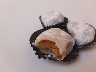 Moaci or Mochi covered in white flour, in Indonesian version. Rice cake filled with sweet peanut...