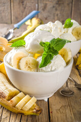 Banana ice cream with min. Vegan fruit ice-cream made of frozen banana in little bowl on wooden background copy space