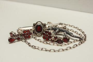 Silver pendant in the shape of a sword on an anchor chain, silver set of earrings and rings with...