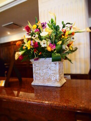 Fototapeta na wymiar Fresh flowers in a square vase