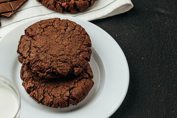 Chocolate cookies on dark table close up