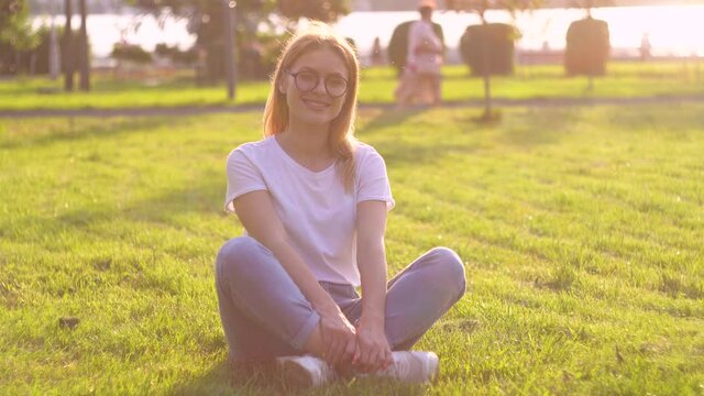 Portrait of woman with with glasses on summer day in the park